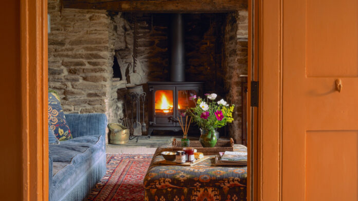 Cosy farmhouse interior with log burner at Cottage Orné on Kip Hideaways